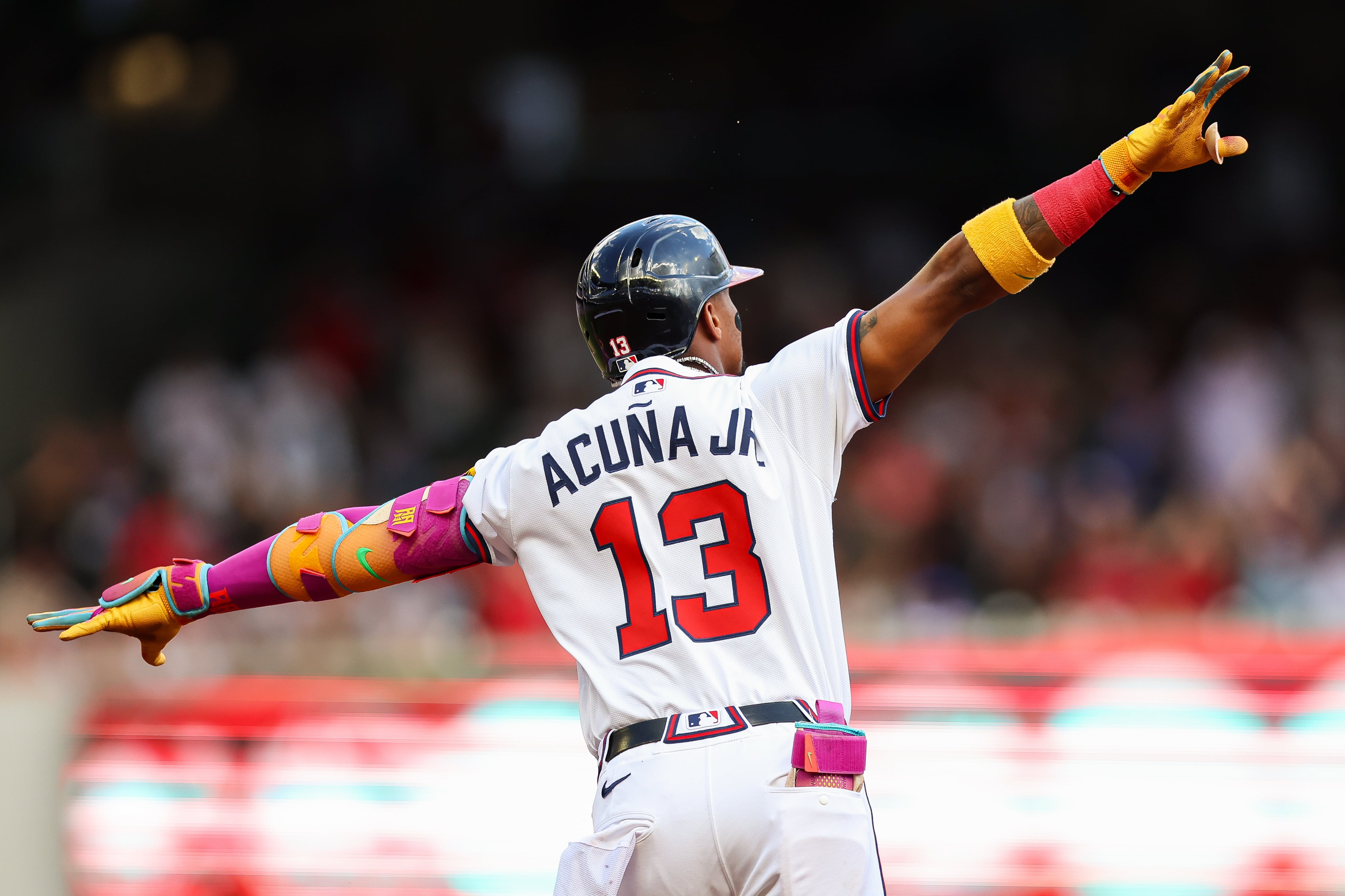 Atlanta Braves' Ronald Acuña Jr. reacts after hitting a two-run home run in the first inning...