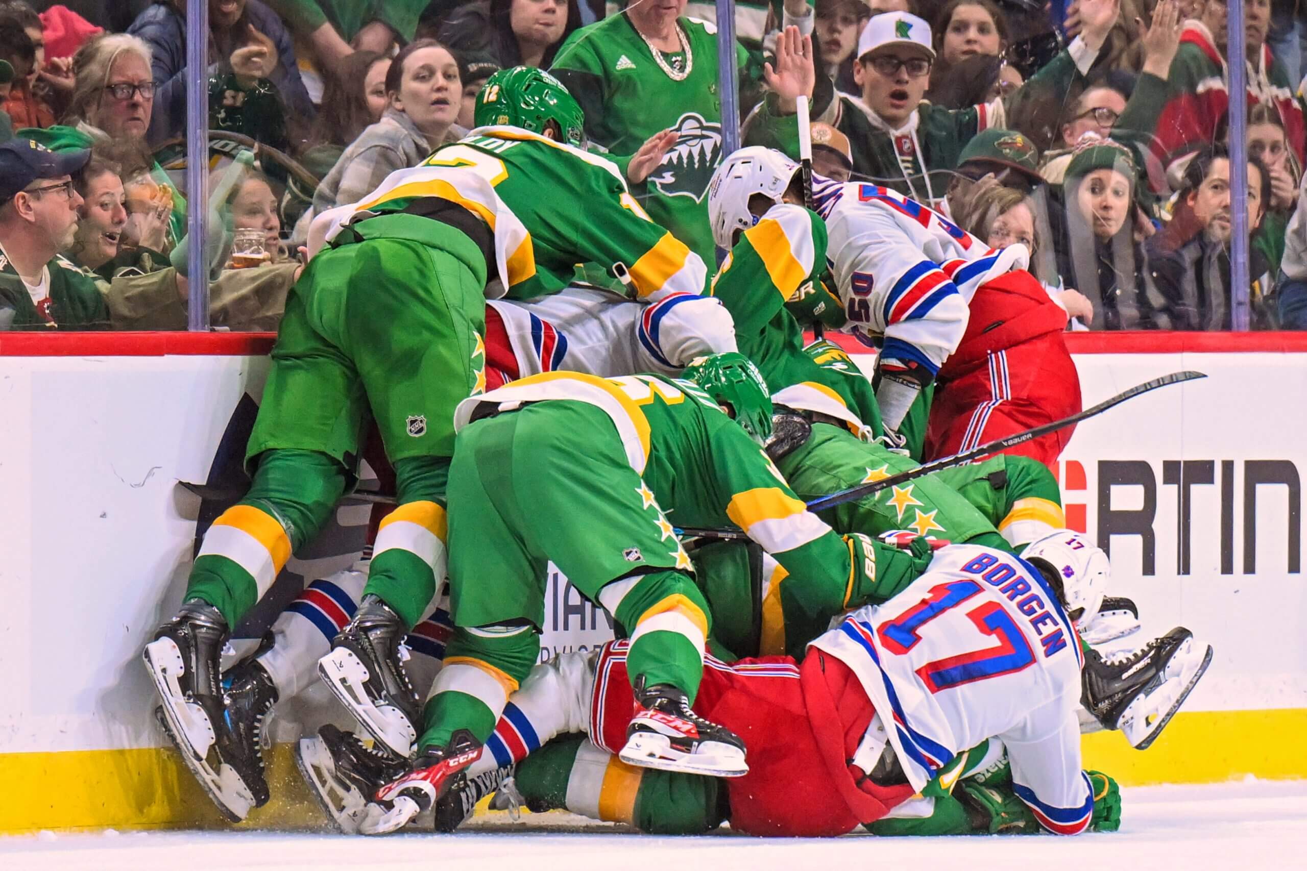 A pile of Wild and Rangers players jump into a fight.