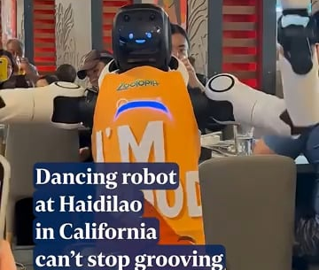 Robot waiter in California Hot Pot restaurant goes rogue and starts dancing and breaking dishware - it's unfazed as human workers try to restrain it