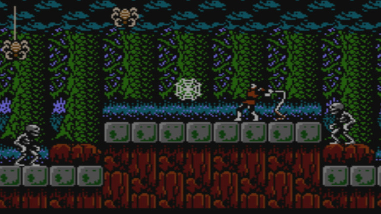 Simon Belmont swings a flail at a cobweb while surrounded by spiders and skeletons in Castlevania II: Simon's Quest