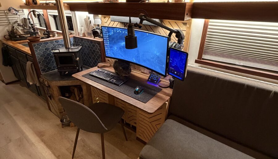 Battlestation in my 2002 converted Blue Bird bus.
Solar powered, Starlink internet, and a cat that keeps getting me killed in Arc Raiders.