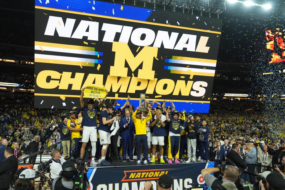 Michigan celebrates after defeating UConn in the NCAA college basketball tournament.
