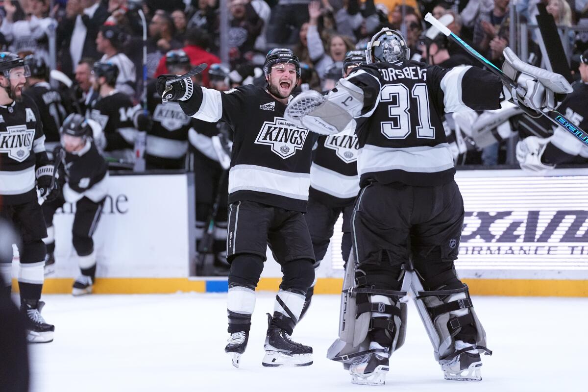 Los Angeles Kings' center Scott Laughton (21) celebrates with goaltender Anton Forsberg.