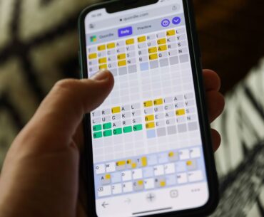 Quordle on a smartphone held in a hand