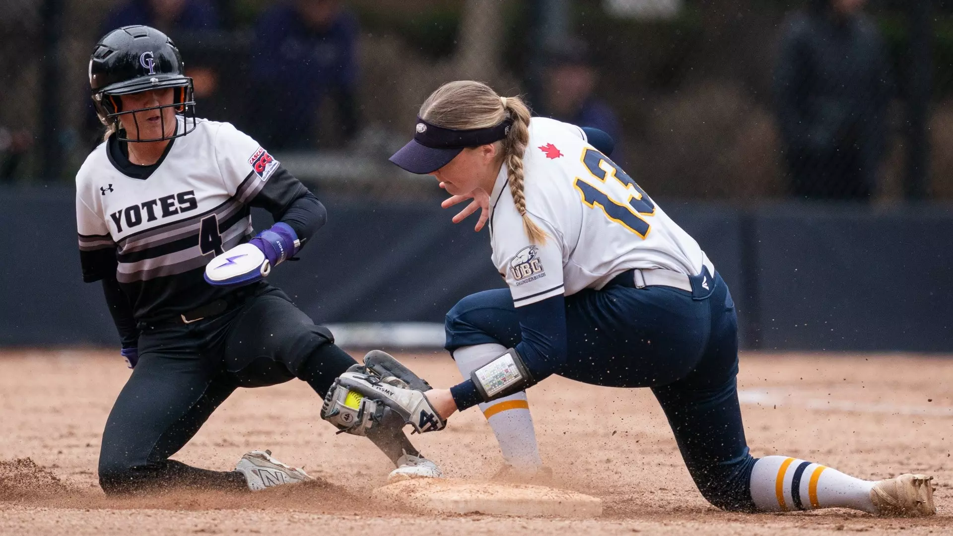 Mattea Burrill stoops down to tag out a Yotes baserunner