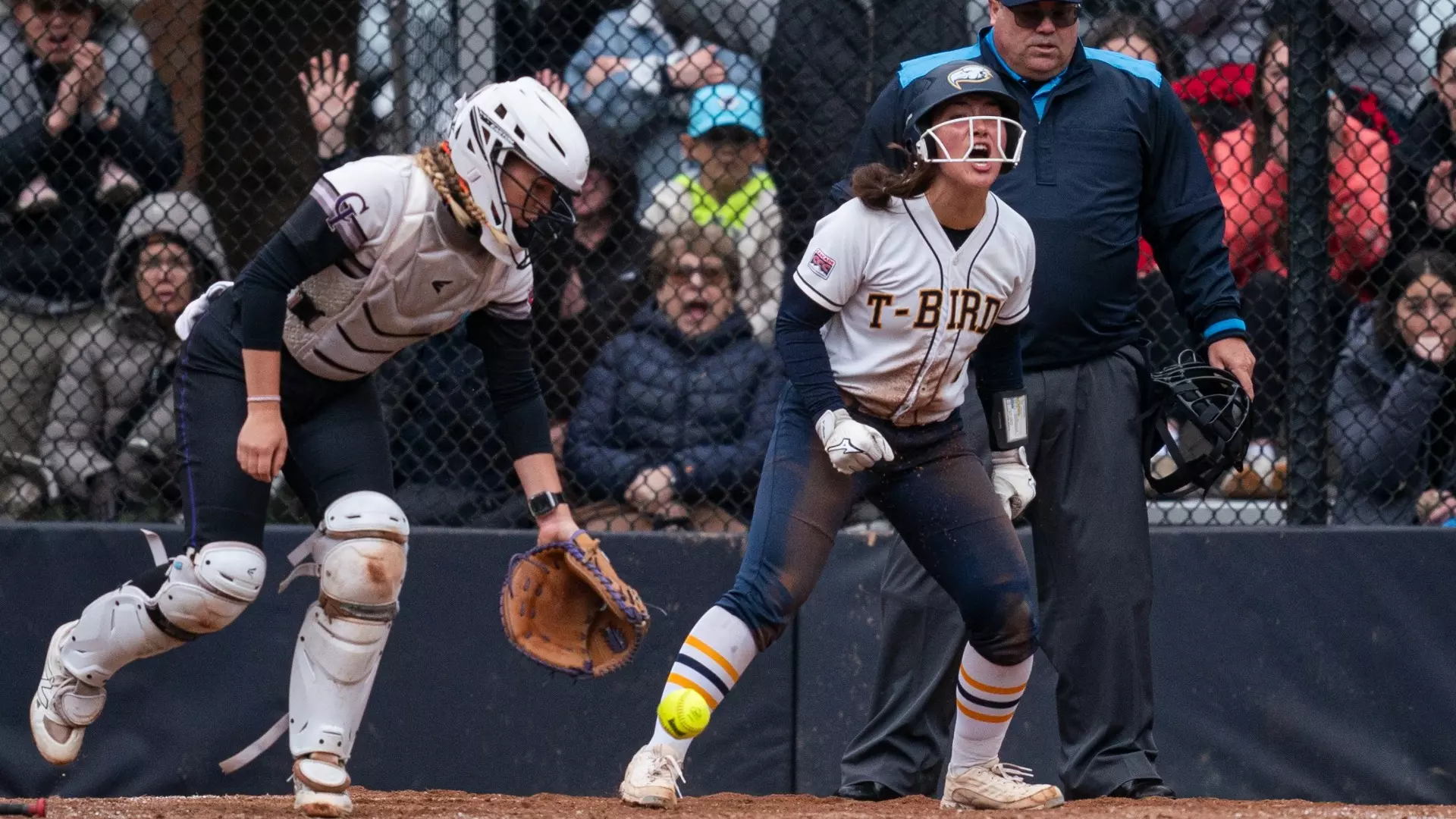 A UBC player celebrates after scoring a run