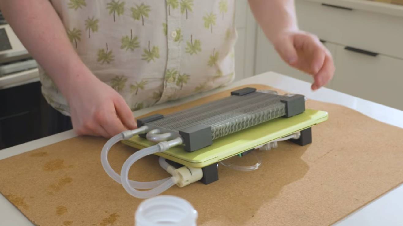 A custom water cooling set up on a MacBook Neo laptop.