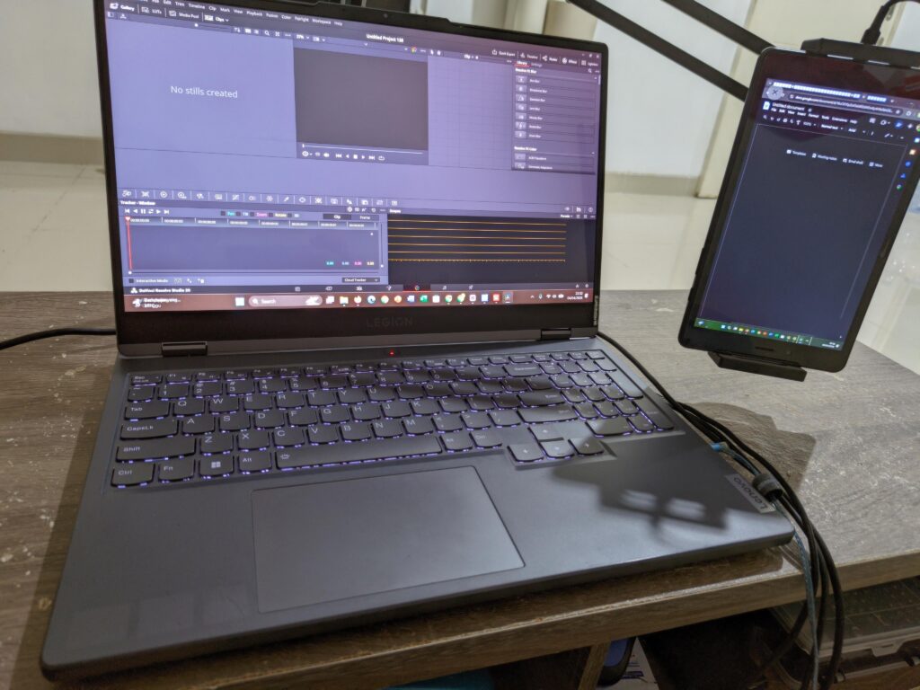 Laptop + old tablet as a second monitor on a cabinet used as a coffee table