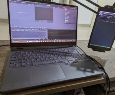 Laptop + old tablet as a second monitor on a cabinet used as a coffee table