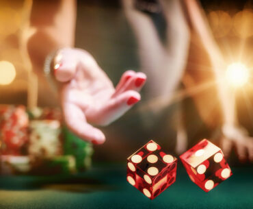 Woman gambling at the craps table at the casino.