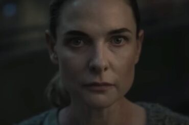 close up of woman with hair pulled back in a ponytail looking resolved