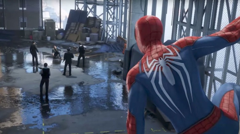 Spider-Man looking at thugs standing beside a puddle in "Marvel's Spider-Man" (2018)