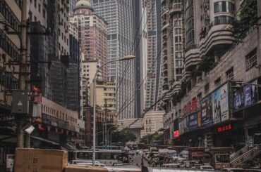 Workers on break with the Raffles City complex looming behind them