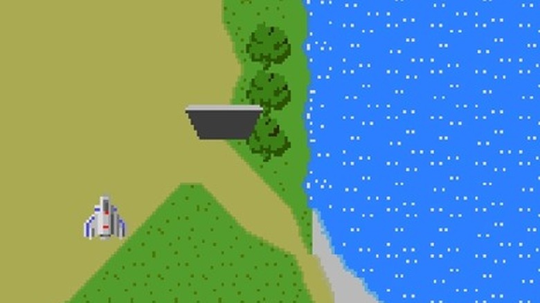 An aircraft flies over a river bank in Xevious