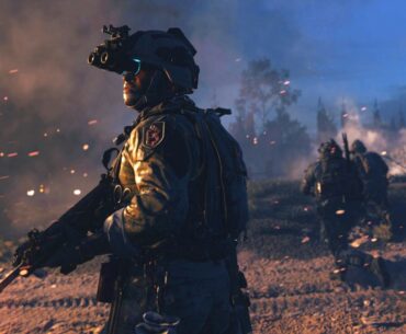 A soldier wearing night-vision goggles stands ready on a battlefield in the game Call of Duty: Modern Warfare II.
