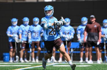 Chase Beyer of Tufts cradles the lacrosse ball