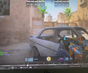 Old man playing on laptop.