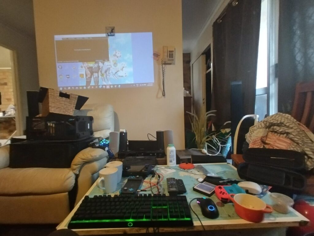 Gpd win 4 based setup with PC graveyard and home theatre system.