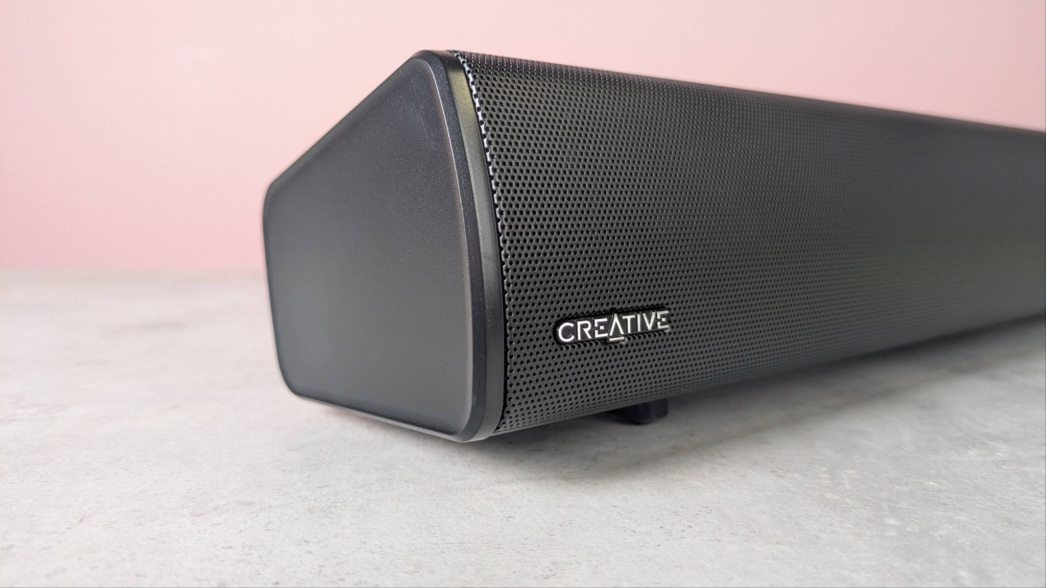 Creative Sound Blaster GS5 on a desk with pink wall in background