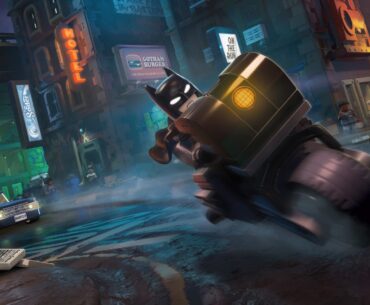A Lego Batman: Legacy of the Dark Knight character rides a motorcycle through a city street with visible signs including 'Gotham Burger' and 'HOTEL'.