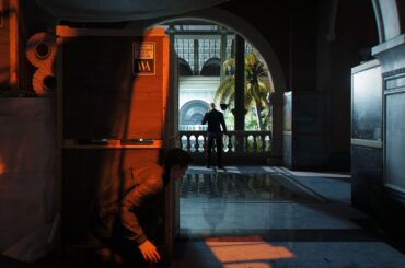007 First Light screenshot showing James Bond crouched behind boxes in stealth