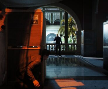007 First Light screenshot showing James Bond crouched behind boxes in stealth