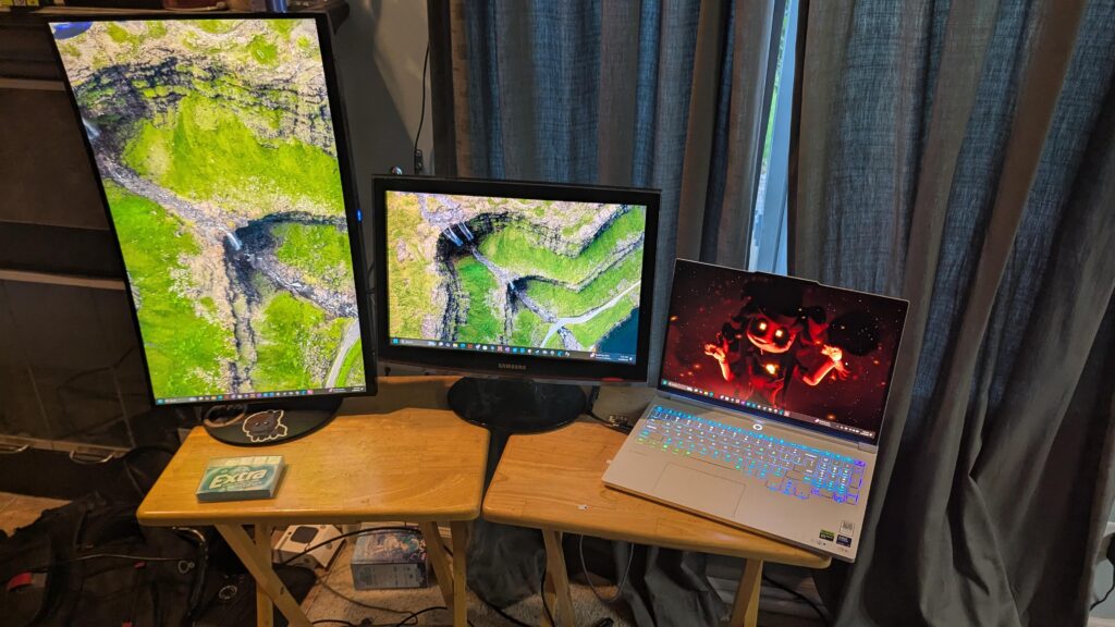 I have no idea what I'm doing. We got a gaming laptop, a curved, VERTICALLY MOUNTED gaming monitor (which is somewhat broken), and we got an old Samsung monitor from 2008, all standing on two fold out tables. If that's not shitty, then I must be doing something wrong.