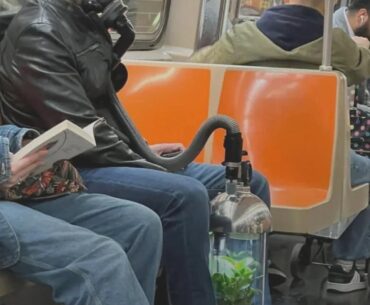 Man breathing from a plant on the train