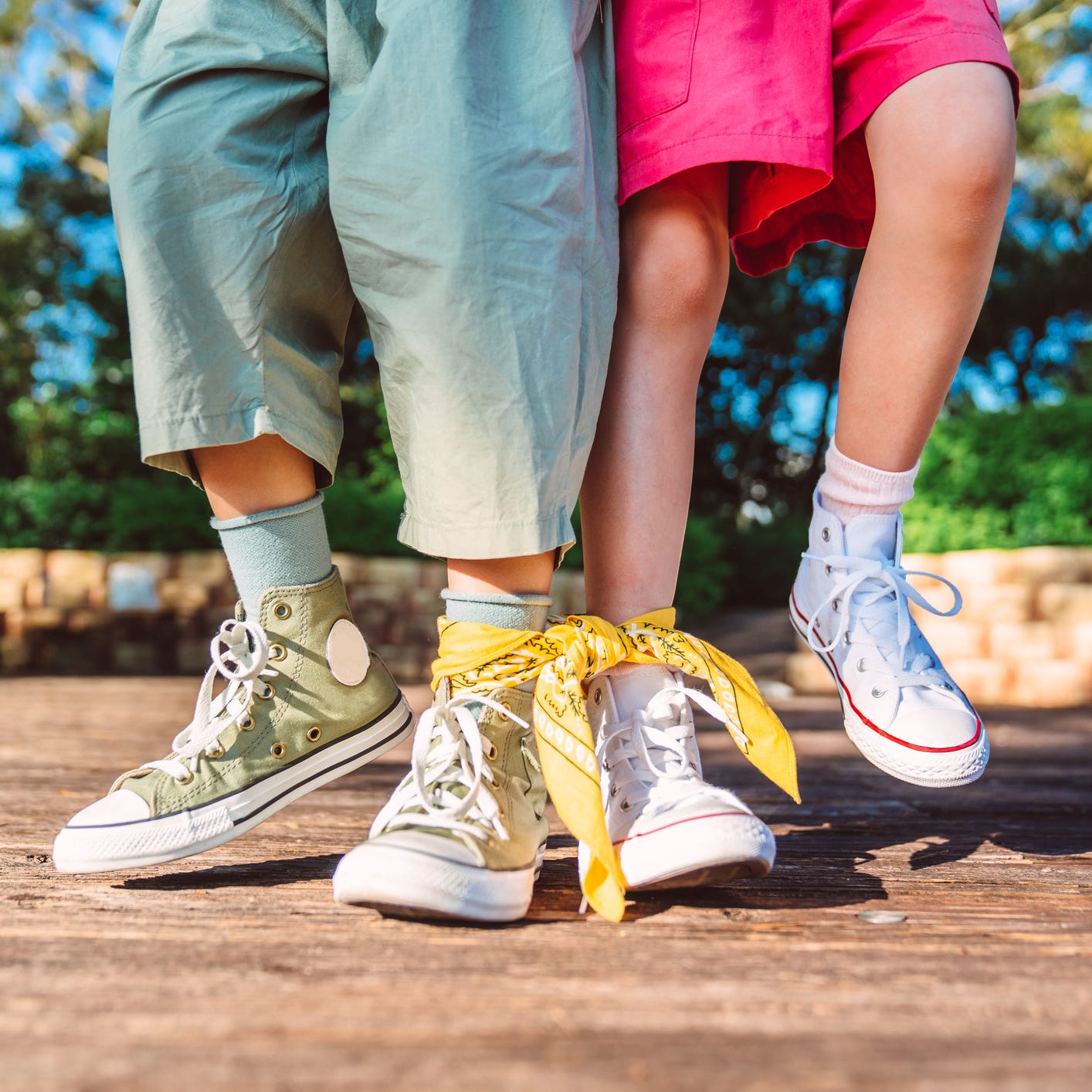 Close-up of children competing in three legged race in park