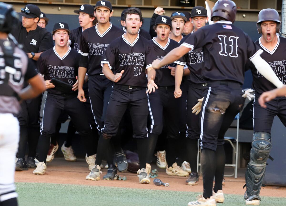Laguna Beach's Lincoln Adams (11) celebrates with his team after scoring against Glendora on Saturday night.