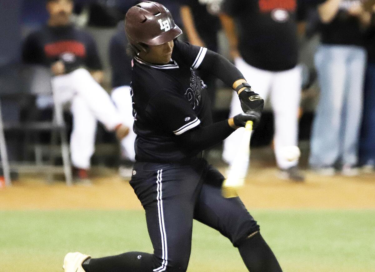 Laguna Beach's Dylan Yencho (12) hits a run-scoring double against Glendora on Saturday night.