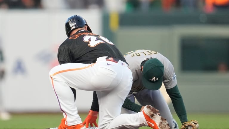 San Francisco Giants' Matt Chapman, left, looks toward Athletics second...