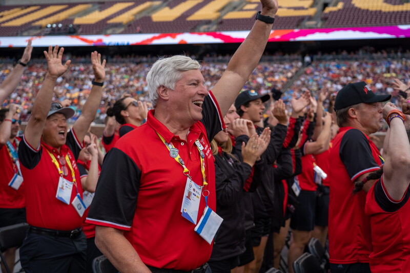 Members of Special Olympics Virginia cheer with their arms raised during the Closing Ceremony of the 2026 Special Olympics USA Games, celebrating alongside thousands of athletes, coaches, and fans inside Huntington Bank Stadium.