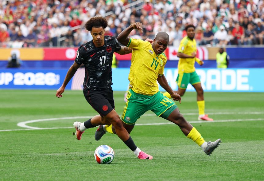South Africa's Mbekezeli Mbokazi, right, defends against Canada's Tajon Buchanan.