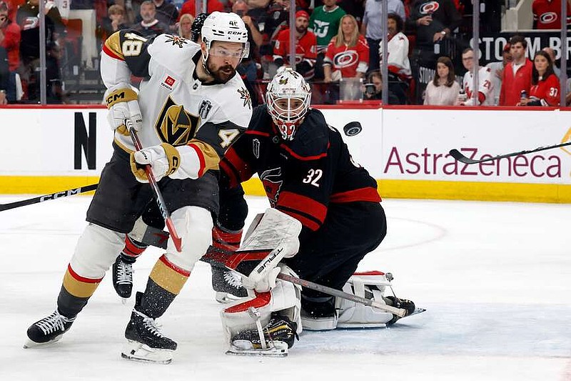 Carolina Hurricanes goaltender Brandon Bussi (32) watches the puck with Vegas Golden Knights' Tomas Hertl (48) during the third period in Game 5 of the NHL hockey Stanley Cup Final series in Raleigh, N.C., Thursday, June 11, 2026. (AP Photo/Karl DeBlaker)