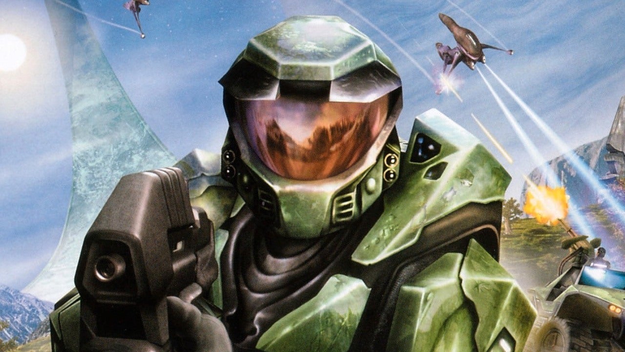 Master Chief from Halo: Combat Evolved aims his MA5B assault rifle as Covenant forces attack in the background, with Halo Installation 04 towering over an active battlefield.