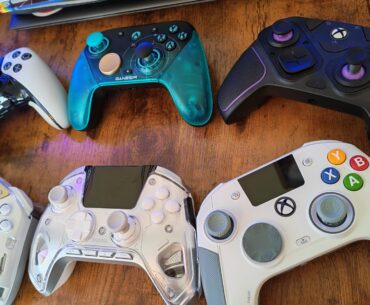 An angled photo of six pro controllers on a gaming desk