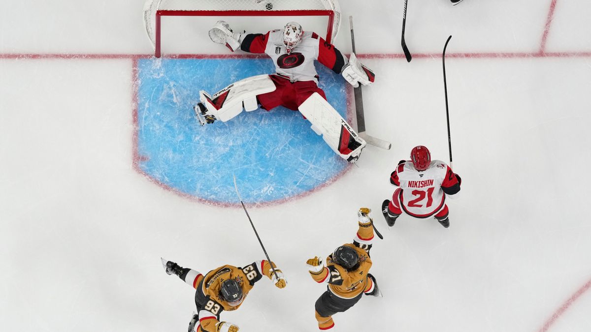 Vegas Golden Knights center William Karlsson (71) and Vegas Golden Knights right wing Mitch Marner (93) celebrate after Vegas Golden Knights defenseman Shea Theodore scored against Carolina Hurricanes goaltender Brandon Bussi (32) during the second overtime in Game 3 of the NHL hockey Stanley Cup Final series, Saturday, June 6, 2026, in Las Vegas. (AP Photo/John Locher)