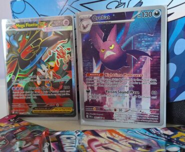 A Golbat and Mega Floette ex card against a Chaos Rising Elite Trainer Box, with boosters visible in the forground