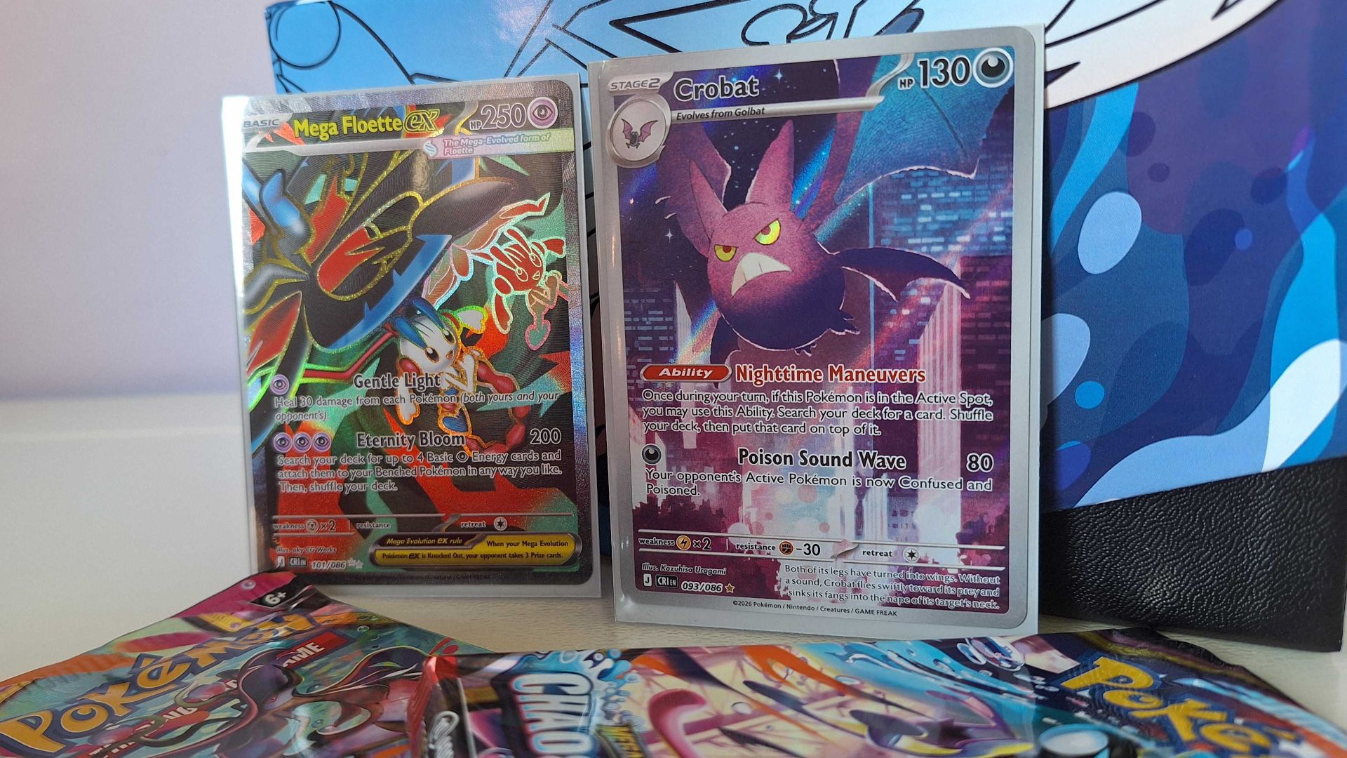 Pokemon card resellers are ruining the hobby, but making my own Pokedex got me back in the game A Golbat and Mega Floette ex card against a Chaos Rising Elite Trainer Box, with boosters visible in the forground
