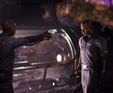 A scene from the game Directive 8020 showing two characters in a tense standoff, with one character aiming a gun at the other who holds a staff, set against a futuristic background.