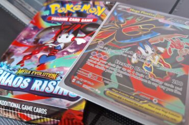 Pokemon Chaos Rising card and booster pack laid out on a dark background