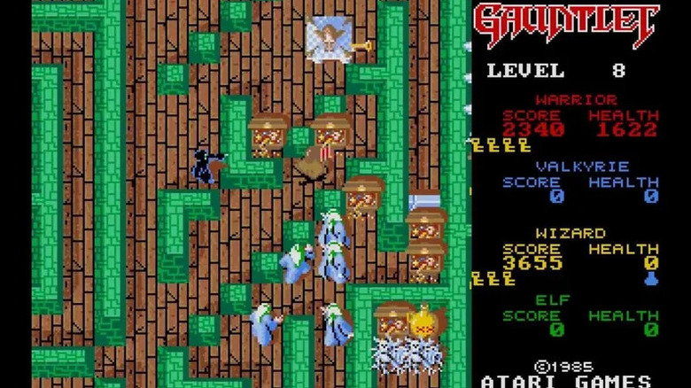 Adventurers loot treasure chests while being swarmed by evil wizards in Gauntlet (1985)