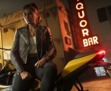 A woman in a leather jacket leans against a motorcycle outside a liquor store at night