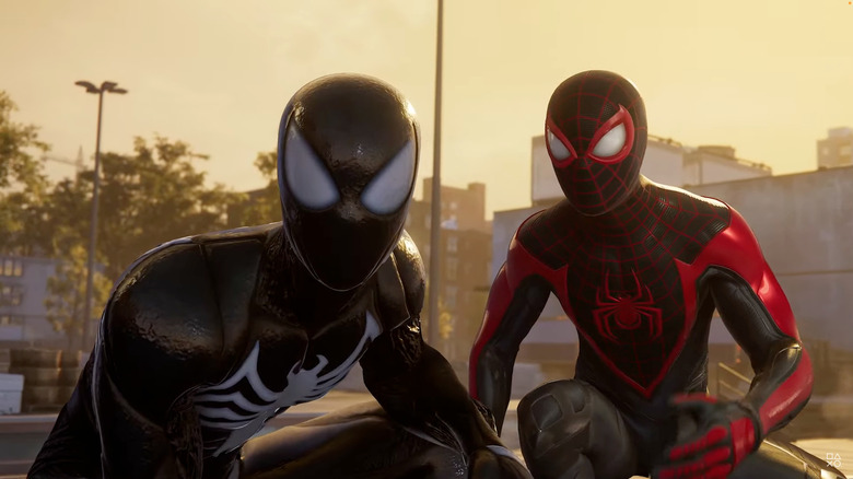 Peter Parker in the symbiote suit sits next to Miles Morales in Marvel's Spider-Man 2