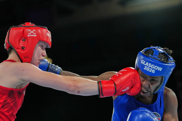 England's Lauren Mackie, left, and Kenya's Amina Faki, compete during the Women's 54kg round of 32 boxing bout during the Commonwealth Games in Glasgow, Scotland, Friday, July 24, 2026. (AP Photo/Kin Cheung)