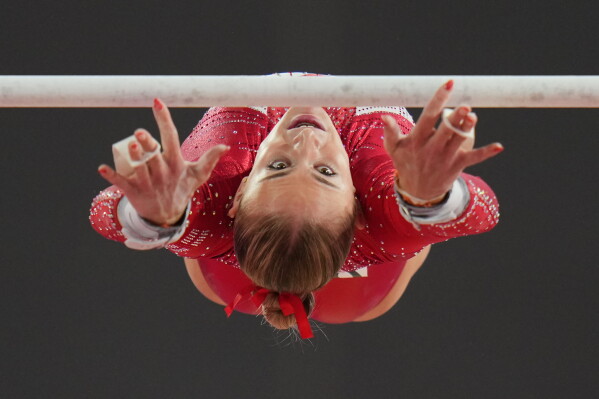 England's Ruby Stacey competes on the uneven bars during the women's team final and individual qualification of Artistic Gymnastics at the Commonwealth Games in Glasgow, Scotland, Saturday, July 25, 2026. (AP Photo/Kin Cheung)
