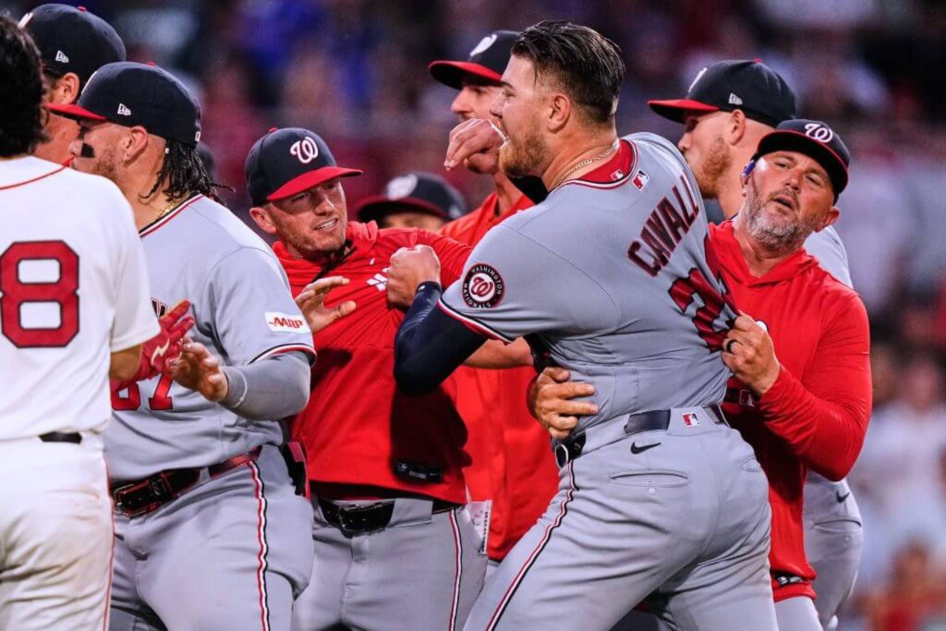 Washington Nationals' Cade Cavalli is held back as tempers flare during a baseball game against the Boston Red Sox on June 30, 2026, in Boston