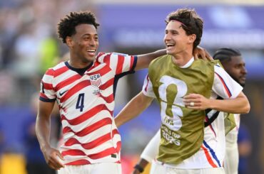 Tyler Adams (left) and Medford's Brenden Aaronson celebrate at the end of the U.S.-Bosnia game.