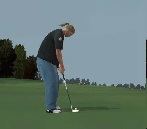 A man in an EA branded tshirt tees off in Tiger Woods 2004